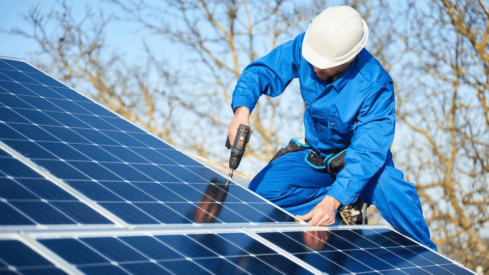 man installing solar